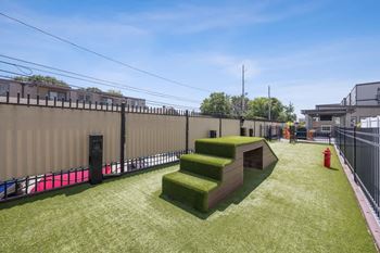 A green lawn with steps and a fence in the background at 45 Madison Apartments, Kansas City, 64111